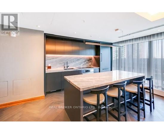A modern kitchen with a dining table and chairs.