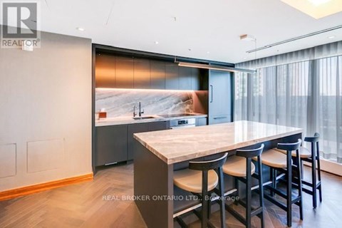 A modern kitchen with a dining table and chairs.