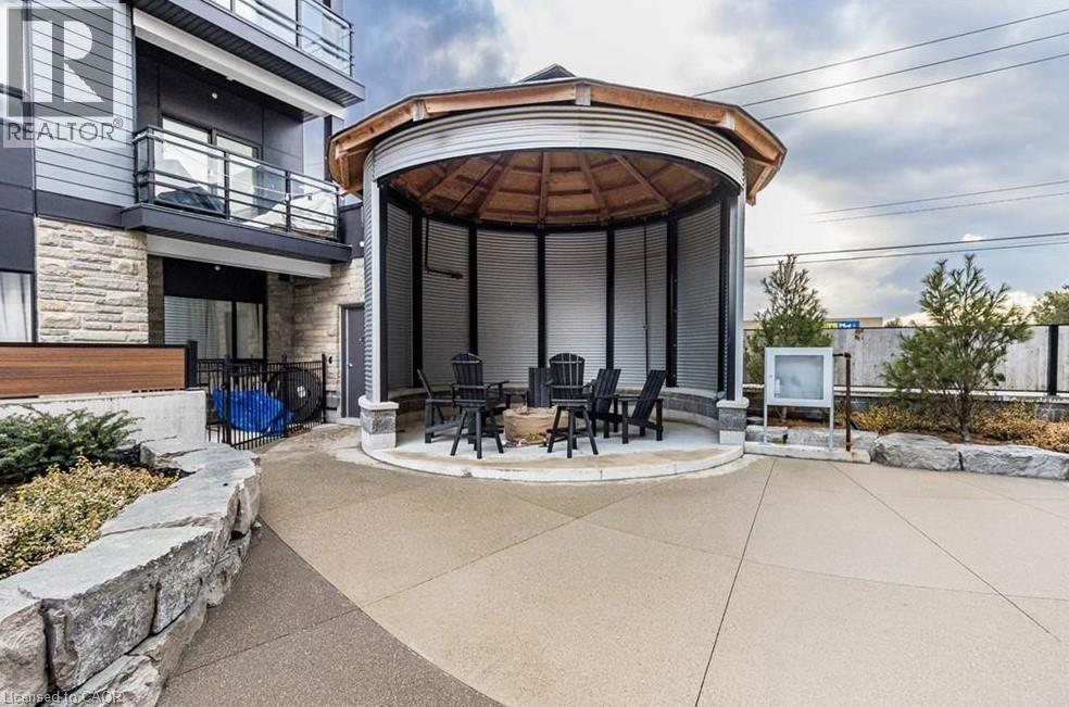 A gazebo-style structure is situated in the middle of a patio area.