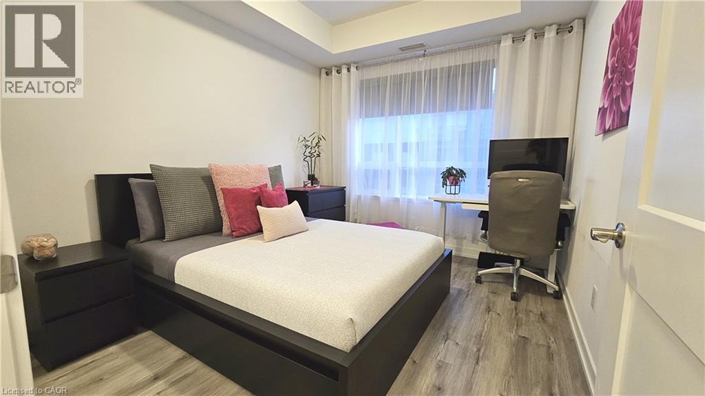 A bedroom with a bed, desk, and chair.