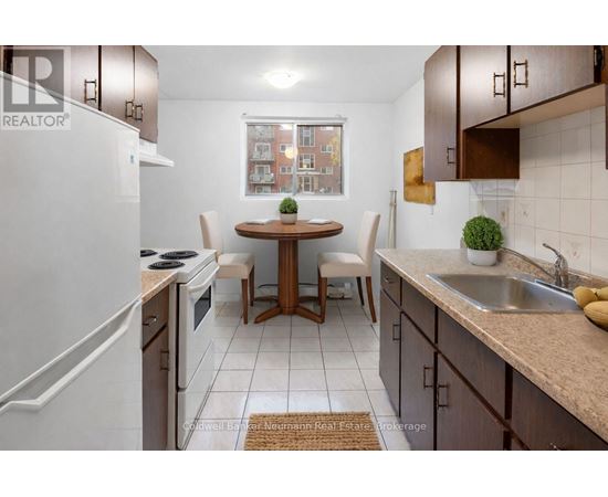 A kitchen with a table and chairs in the middle.