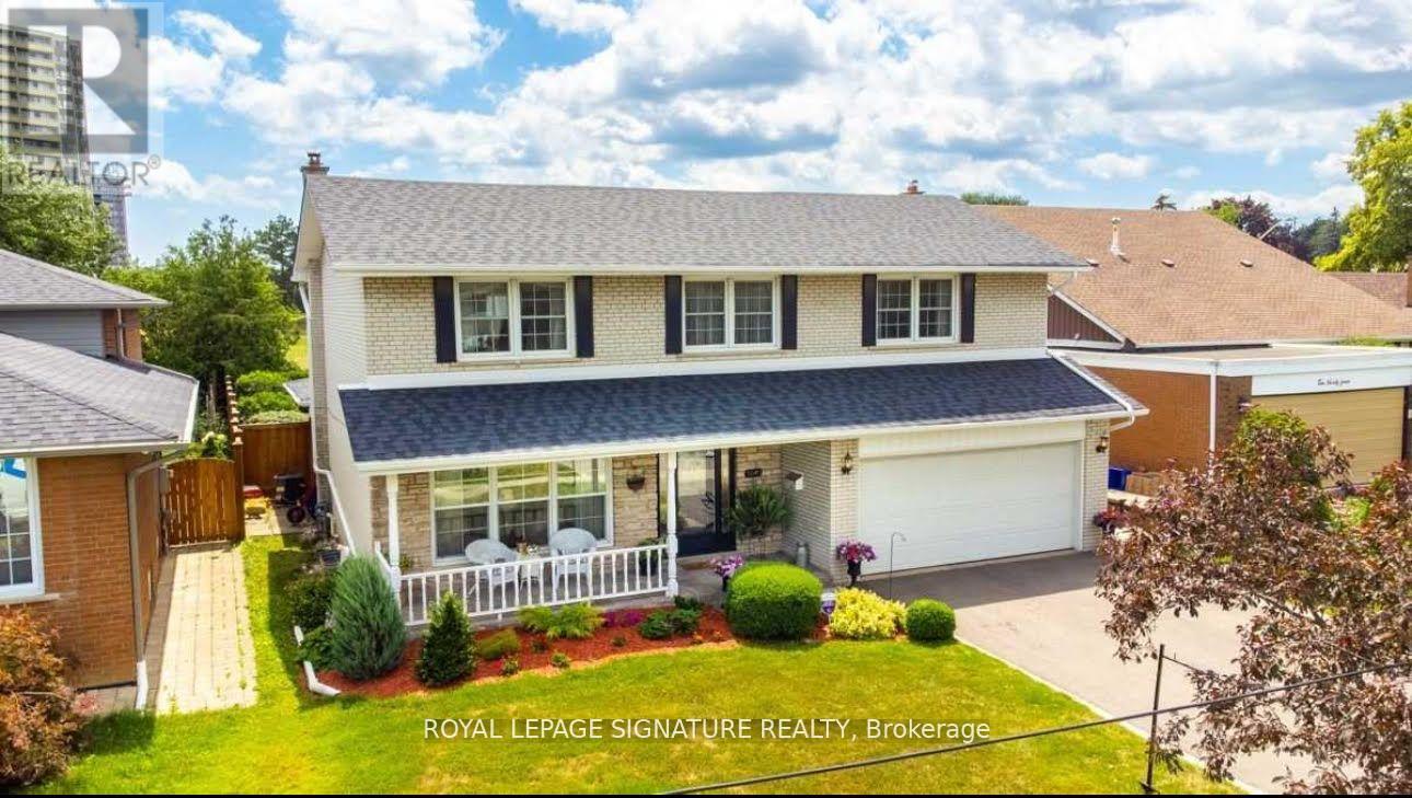 A house with a white fence and a garage is for sale.