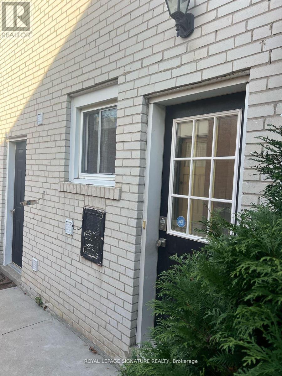 A white brick building with a sign that says "Royal LePage Signature Realty Brokerage".
