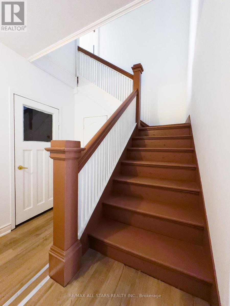 A staircase with a white railing and wooden steps.