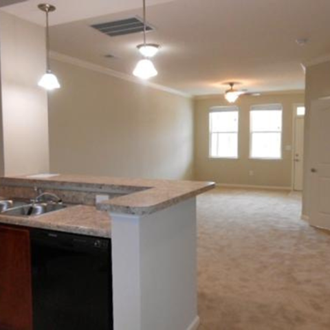 A kitchen with a sink and a counter.