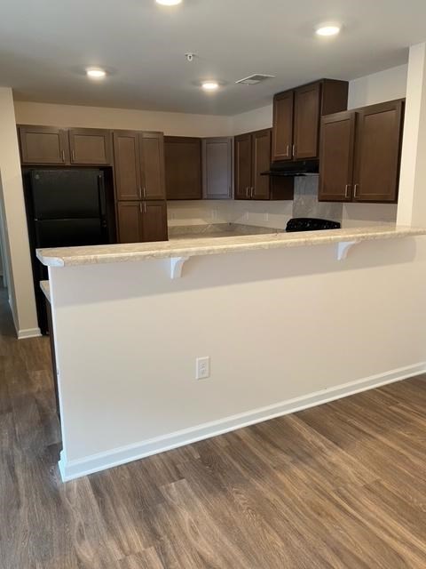 A kitchen with brown cabinets and a white countertop.