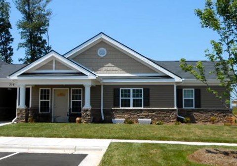 A house with a grey roof and white trim.