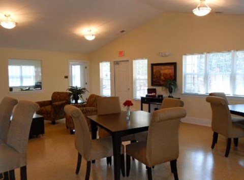 A dining room with a table and chairs.