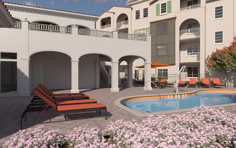 A pool area with a bench and flowers in front of a building.