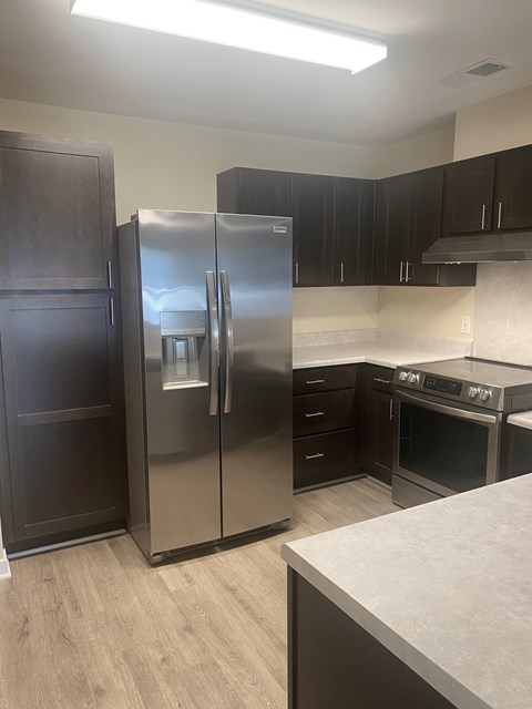 A kitchen with a stainless steel refrigerator and oven.