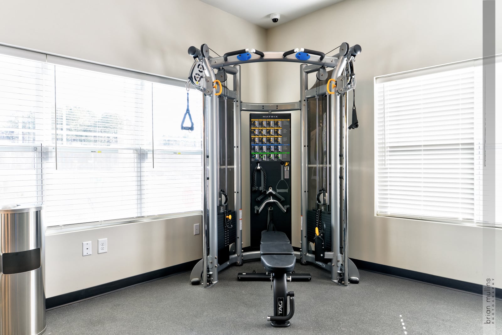 A gym with a rowing machine and a weight machine.