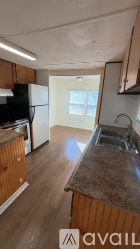 A kitchen with wooden cabinets and a granite countertop.