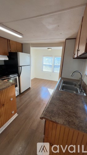 A kitchen with wooden cabinets and a granite countertop.