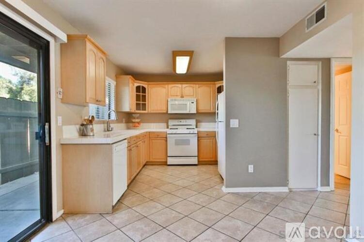 A kitchen with wooden cabinets and a white countertop.