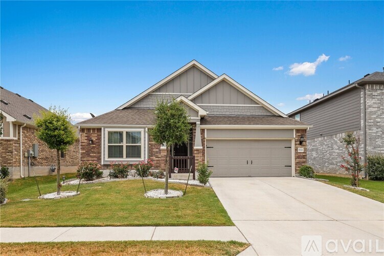 A house with a garage and a driveway in front.