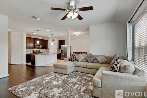 A living room with a beige couch and a rug in the foreground.