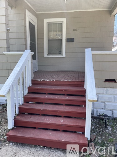 A set of stairs leading to a door with the number 1016 on it.