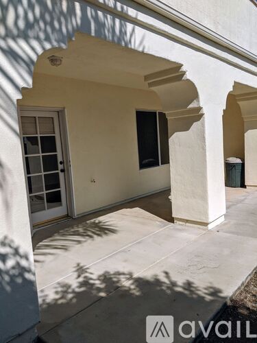 A white building with arches and a door.