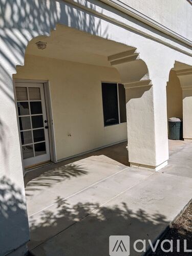 A white building with arches and a door.