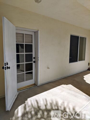 A white door with a glass window is open.