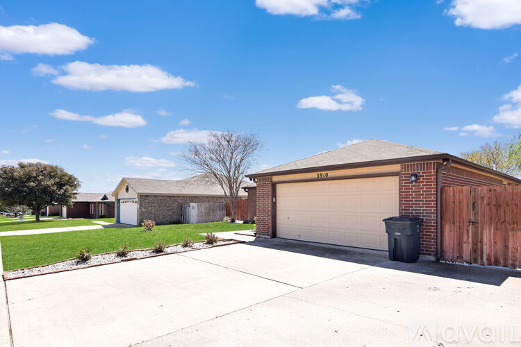 A house with a brown roof and a tree in front of it.