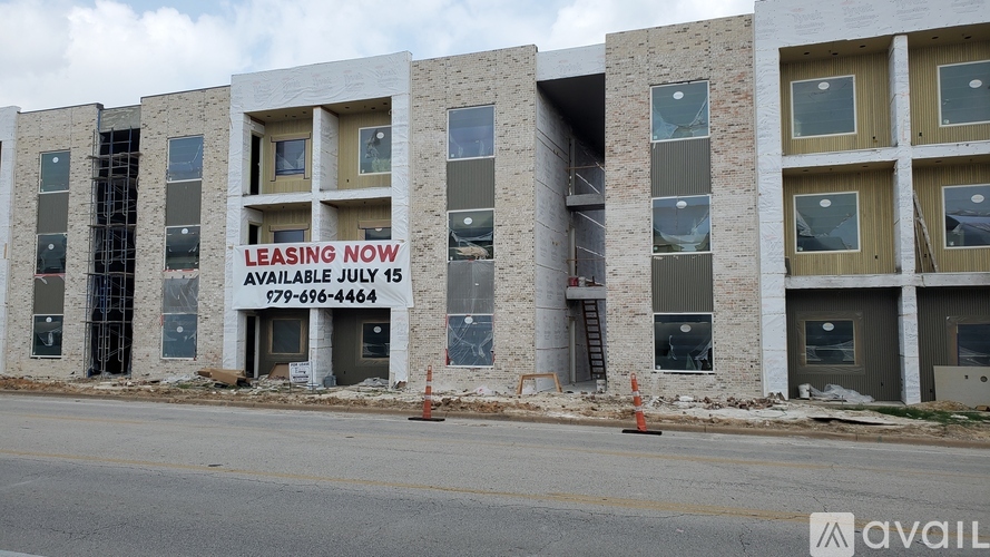 A building with a sign that says "LEASING NOW" is available for lease starting July 15.