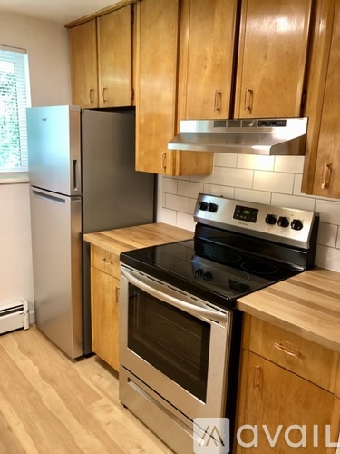 A kitchen with wooden cabinets and a black stove top oven.