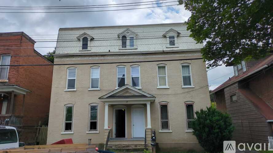 A two-story house with a white front door and a small porch.