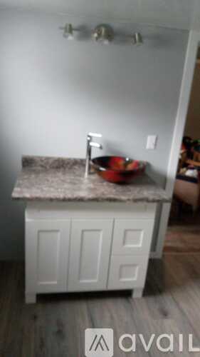 A kitchen island with a bowl of fruit on it.