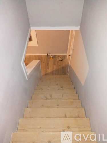 A staircase with wooden steps leading to a landing.