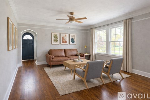 A living room with a brown leather couch and a wooden coffee table.