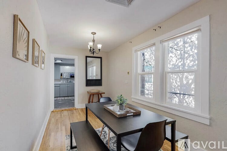 A dining room with a table and chairs.