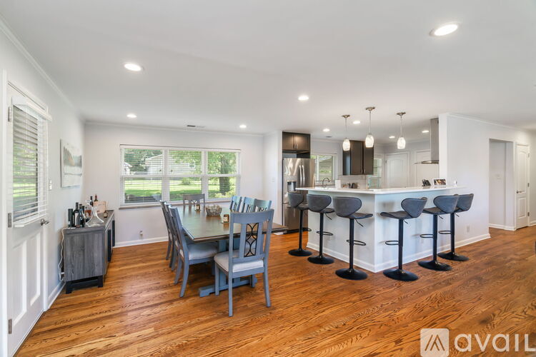 A modern kitchen with a dining table and chairs.