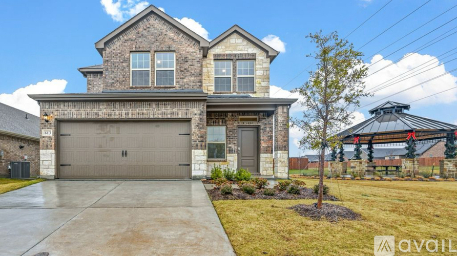 A house with a stone facade and a large garage door.