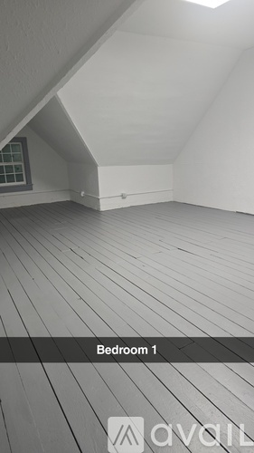 Bedroom 1 has a window and a wooden floor.
