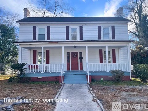 A white house with red trim and a red door is for rent by room.