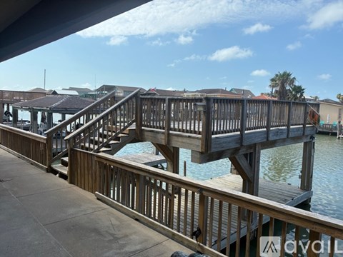 A wooden dock with stairs leading to a body of water.
