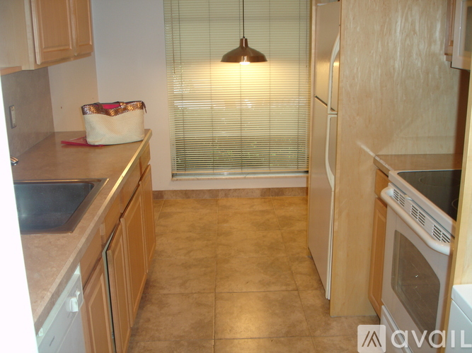A kitchen with wooden cabinets and a white fridge.