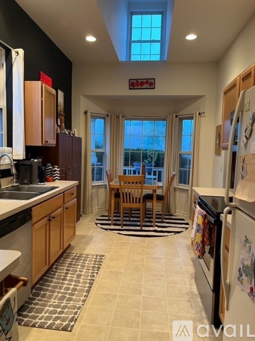 A kitchen with a table and chairs in the middle of the room.