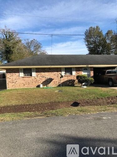 A house with a brown brick exterior and a grey roof.