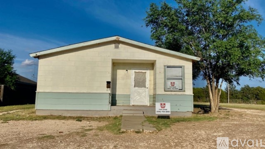 A small house with a sign in front of it.