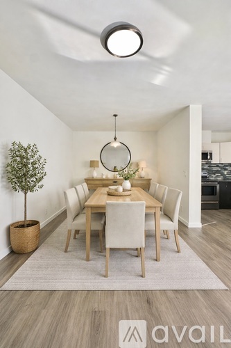A modern dining room with a round table and chairs.