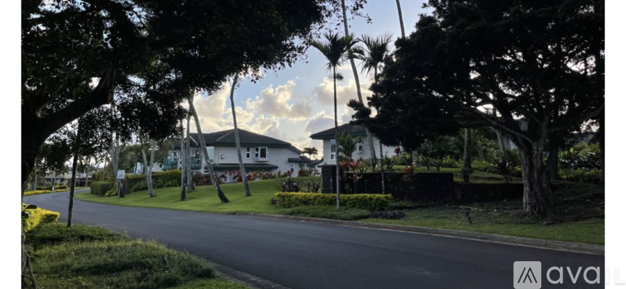 A street view with a house and trees on the side.