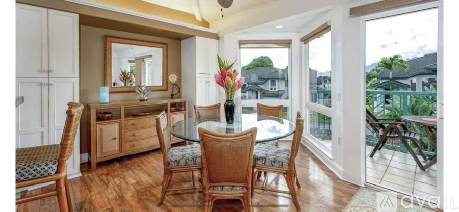 A dining room with a glass table and chairs.