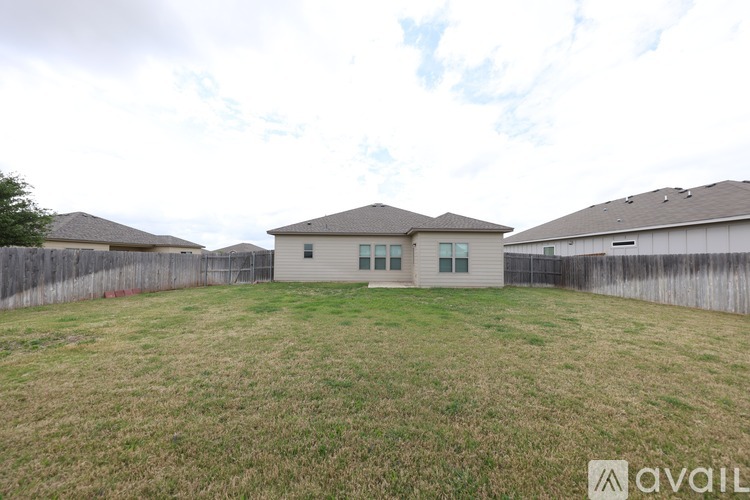 A house with a fence and a grassy yard is available for sale.