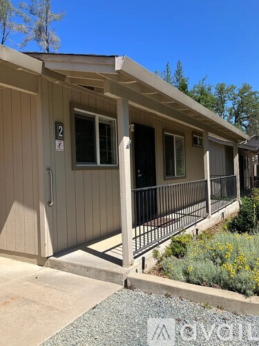A small house with a porch and a door with a number 2 on it.