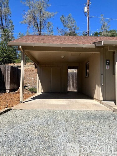 A small building with a door and a sign on the wall.