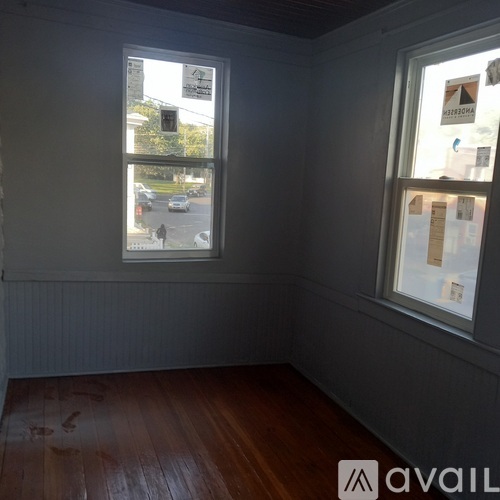 A room with a window showing a street view.