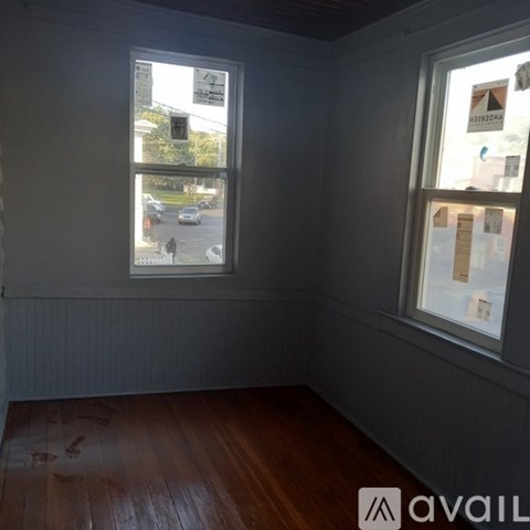 A room with a window showing a street view.
