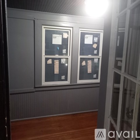 A wall with two framed items on it.